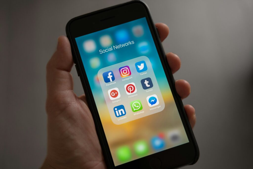 pexels-photo-607812-607812 A smartphone displaying various social media icons held in a hand, showcasing modern communication apps.